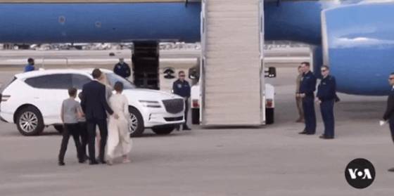 A white Genesis GV80 SUV is parked next to a U.S. military aircraft for U.S. President Donald Trump and his family in West Palm Beach as Trump headed to Washington for his second inauguration in January. [SCREEN CAPTURE]
