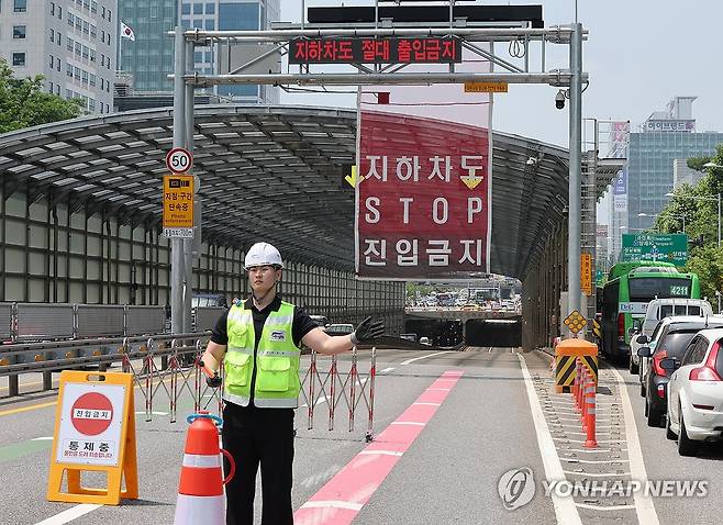 '집중호우 시 진입금지' (서울=연합뉴스) 서명곤 기자 = 18일 본격적인 장마철을 앞두고 서울 서초구 염곡동서지하차도에서 서울시 관계자들이 집중호우 시 가동되는 차량 진입 차단 설비 작동 상태를 점검하고 있다. 오 시장은 이날 오전 신림공영차고지 빗물저류조와 서초구 염곡동서지하차도를 차례로 방문해 시설 작동 상태를 살폈다. 2025.6.18 seephoto@yna.co.kr