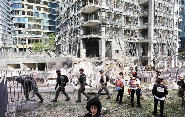 이스라엘 라마트간 시내 고층 건물 여러 채가 이란의 미사일 공격을 받아 크게 파손된 가운데 19일(현지시간) 구조대원과 군인들이 주변을 수색하고 있다. 이스라엘은 이란이 민간인을 겨냥했다고 강력 반발했다. AP연합뉴스