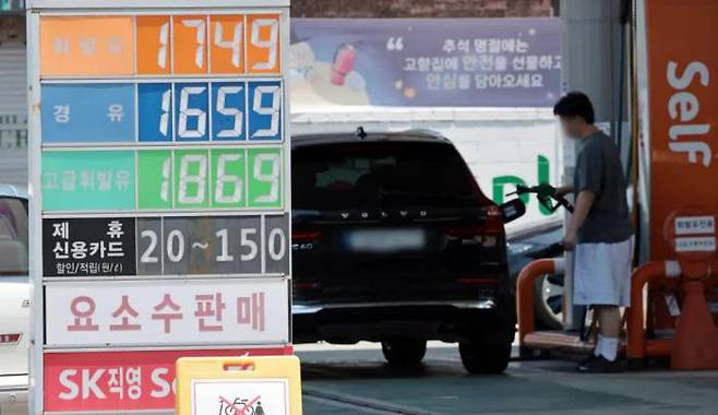 Gasoline and diesel prices are displayed at a gas station in Seoul on June 22. / Yonhap News