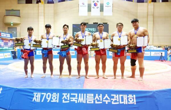 경장급(75kg 이하)이주영(태안군청), 소장급(80kg 이하)우재혁(영남대), 청장급(85kg 이하)정민궁(증평군청), 용장급(90kg 이하)고민혁(대구대), 용사급(95kg 이하)이청수(증평군청), 역사급(105kg 이하)정상호(정읍시청), 장사급(140kg 이하)김찬영(정읍시청)이 메달을 메고 상장과 황소트로피를 들고 다같이 기념사진을 찍고 있다. 사진┃대한씨름협회