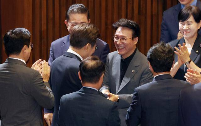 이재명 대통령이 26일 국회에서 추가경정예산 시정연설을 위해 본회의장에 입장하며 김민석 국무총리 후보자와 악수하고 있다. 왕태석 선임기자