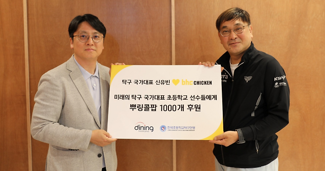 ‘뿌링콜팝 1000개’ 후원 전달식에서 박원철(왼쪽) 다이닝브랜즈그룹 홍보담당 이사와 서민성 한국초등학교탁구연맹 실무부회장이 기념 촬영을 하고 있다. [다이닝브랜즈그룹 제공]