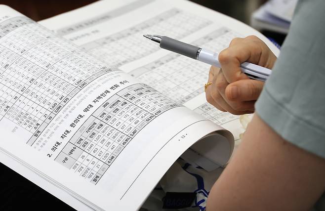 8일 서울 성북구 종로학원에서 열린 6월 모의평가 토대 합격점수 예측 및 2026 수시 정시 전략특집설명회에서 학부모들이 강사의 설명을 들으며 자료를 살피고 있다. [연합]