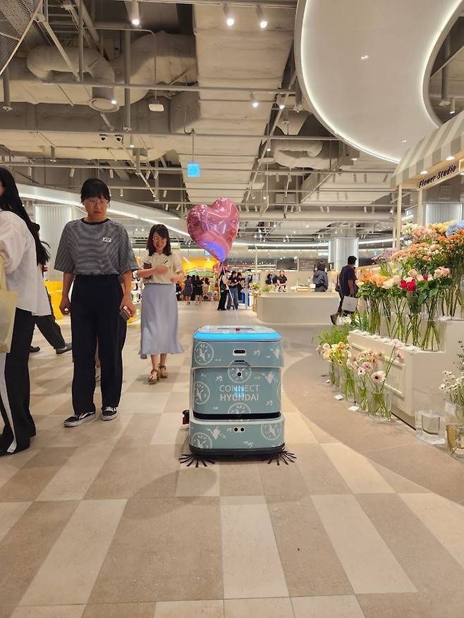 커넥트현대 청주점 인턴 직원으로 채용된 AI 청소로봇 ‘휠리 J40’이 매장 청소를 하고 있다. [사진 제공=라이노스]