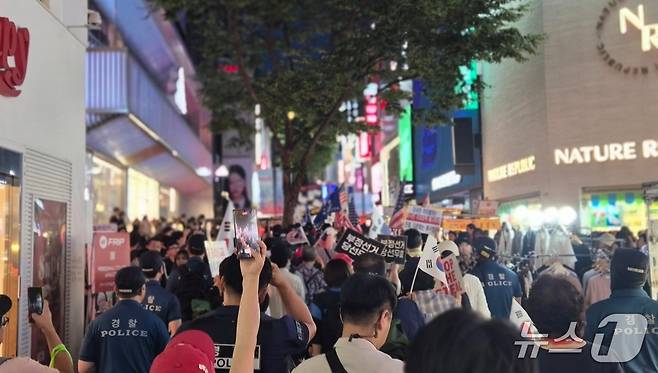 2일 오후 서울 중구 명동 거리에서 자유대학 집회 참가자들이 부정선거 의혹을 제기하며 외국인 관광객들 사이로 행진하고 있다.  ⓒ 뉴스1 남해인 기자