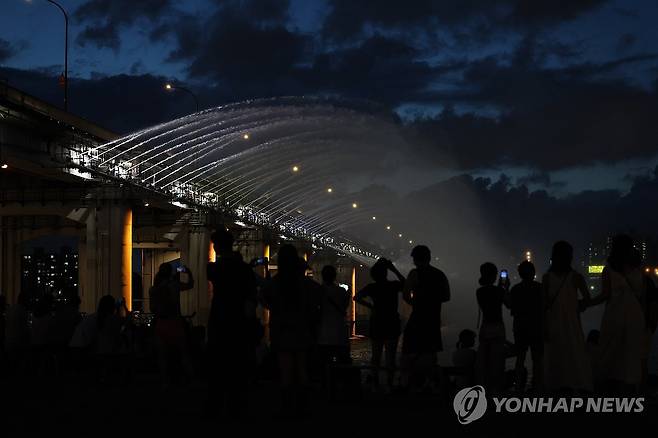 열대야 계속 (서울=연합뉴스) 임화영 기자 = 무더위에 열대야까지 겹친 1일 서울 서초구 반포한강공원을 찾은 시민들이 달빛무지개분수를 보며 더위를 식히고 있다. 2025.7.1 hwayoung7@yna.co.kr