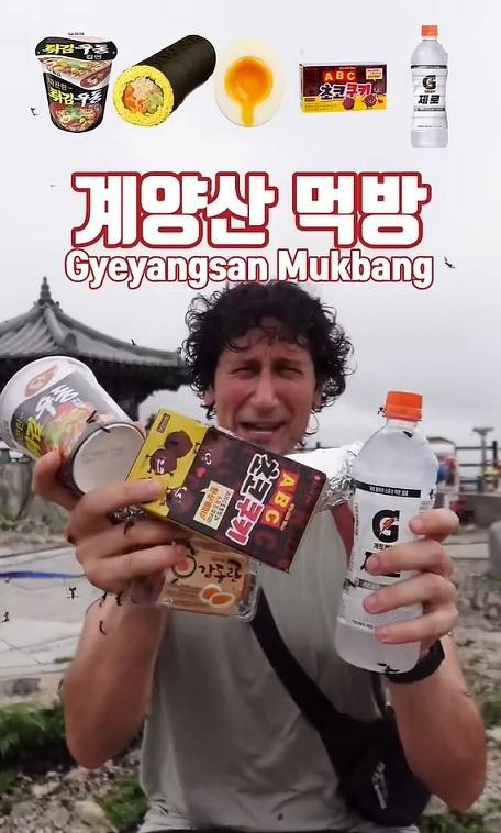 A screengrap of TikToker Chambo's video in which he eats instant noodles, gimbap and snacks while lovebugs crawl on his face and cling to his clothes. (TikTok)