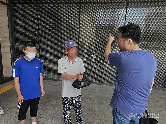 4일 오후 광주 서구 광주종합버스터미널(유스퀘어) 앞에서 광주다시서기종합지원센터 상담요원이 노숙인에게 도시락을 전달하며 안부를 묻고 있다. 강주비 기자