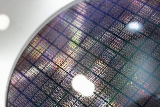 A silicon wafer on display during the Smart Manufacturing Expo in Taipei, Taiwan, on April 18, 2025. The expo is a leading event highlighting the latest innovations in intelligent manufacturing, featuring technologies like automation, AI, IoT, and robotics. [EPA/YONHAP]