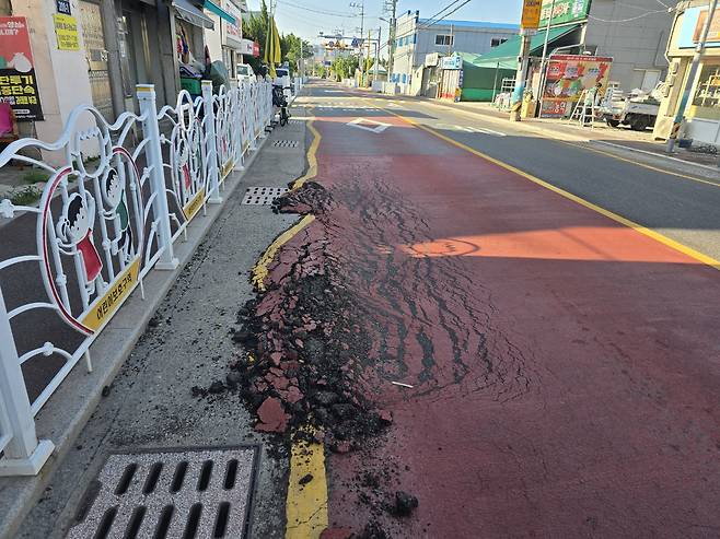 This photo released on July 7 shows a section of asphalt in Buk District, Ulsan, recently damaged and appearing as if it has melted. [YONHAP]