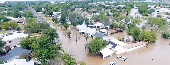 미국 텍사스주 샌앤젤로의 주택가가 이 지역 콘초 강을 따라 쏟아진 폭우로 인해 급류가 발생하면서 침수된 모습이다. AP통신에 따르면 이날 텍사스주 중부 지역에 내린 폭우로 과달루페 강이 범람하면서 캠핑 중이던 어린이 28명이 사망하는 등 재해지역에서 최소 80명이 숨졌다. 사망자 수가 더 늘어날 것으로 보인다. 도널트 트럼프 미 대통령은 대형 인명 피해가 발생한 텍사스 커 카운티를 재난지역으로 선포했다.   [로이터]