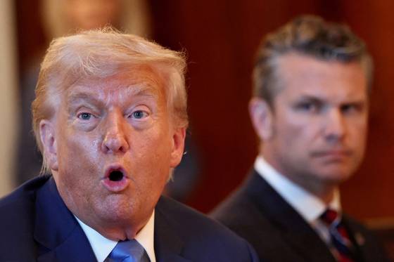 U.S. Defense Secretary Pete Hegseth, right, looks at U.S. President Donald Trump as he speaks during a bilateral dinner with Israeli Prime Minister Benjamin Netanyahu at the White House in Washington on July 7. [REUTERS/YONHAP]