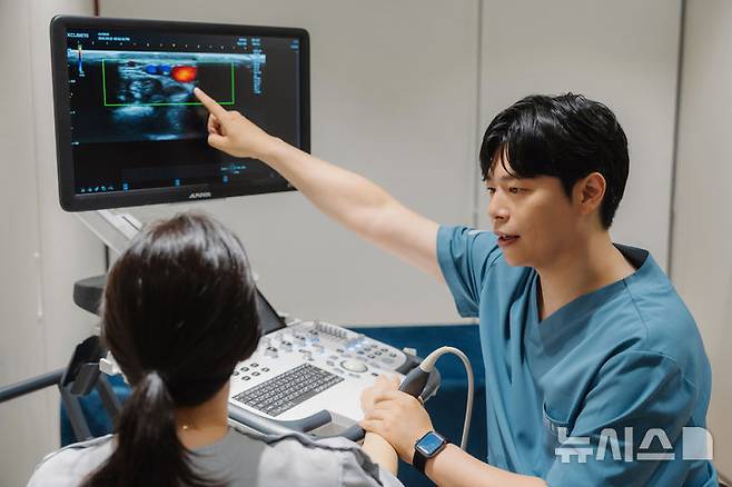 [서울=뉴시스] 홍지성 연세센트럴재활의학과의원 원장(재활의학과 전문의)이 골프 엘보우 환자에게 상태와 치료법을 설명하고 있다. (사진= 연세센트럴재활의학과의원 제공) 2025.07.10. photo@newsis.com.