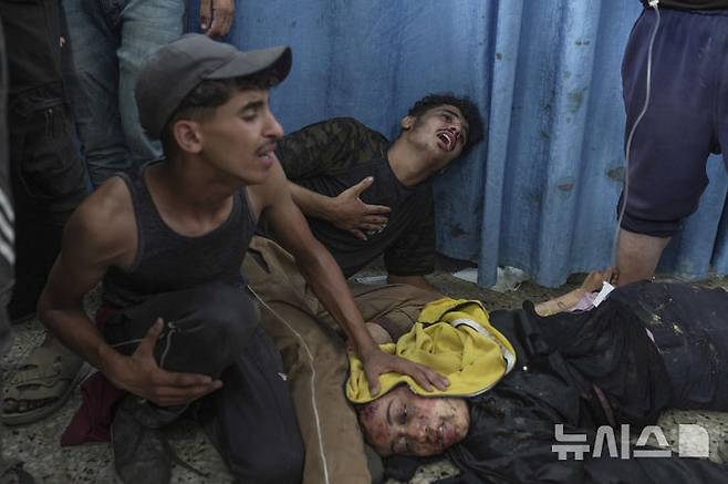 [시파=AP/뉴시스] 12일(현지 시간) 가자지구 시파에서 팔레스타인인이 이스라엘 군 공습으로 부상을 입고 쓰러져 있다. 2025.07.14.