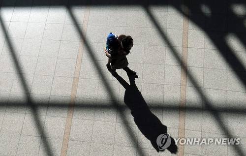 손주를 등에 업고 [연합뉴스 자료사진. 손주를 등에 업고 귀하는 할머니]