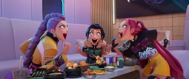 A scene from "KPop Demon Hunters" in which Rumi, Joy, and Mira enjoy a meal together on their private jet. (Netflix)