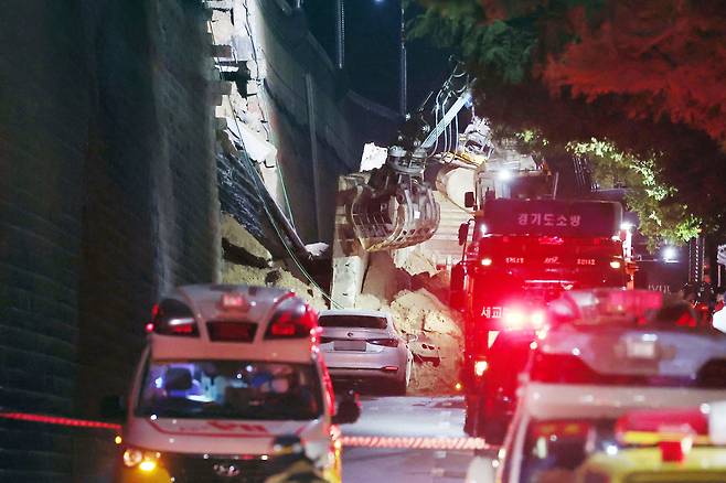 An excavator works to clear debris following the collapse of a retaining wall in Osan, Gyeonggi Province, on Wednesday. (Yonhap)