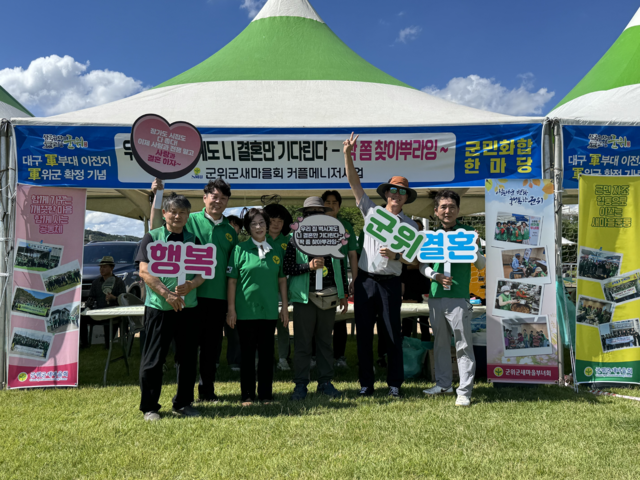 대구 군위군새마을회가 결혼문화 확산을 통한 인구위기 극복을 위해 팔걷고 나섰다. 군위새마을회가 지난 7월 1일 군부대 이전 기념 군민화합 한마당 잔치에서 결혼문화 확산 캠페인을 벌이는 모습. 군위새마을회 제공