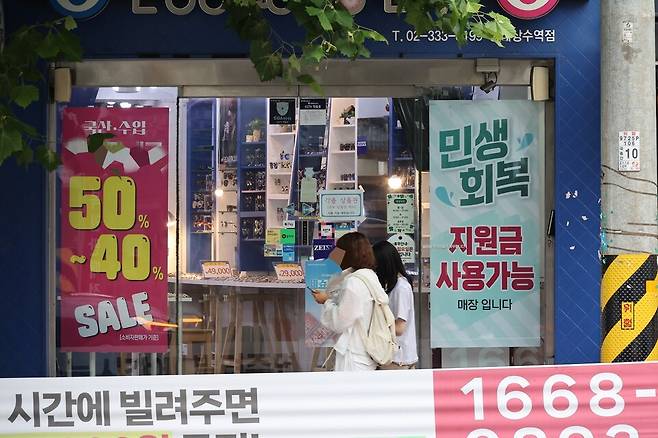 '그간 갈등을 빚어 온' 광주시와 5개 자치구가 민생회복 소비쿠폰 지급을 위한 재원 분담 비율을 5대5로 정하는 방향으로 합의했다. 하지만 오는 21일 민생 소비쿠폰 지급을 앞두고 급한 불은 껐지만 갈등의 불씨는 여전하다는 지적이 나온다. 광주시가 협상카드로 제시한 자치구 재원 보전대책인 특별교부금 지급 규모를 놓고는 입장 차를 보이고 있기 때문이다. 양측이 특교금 최종 규모를 두고 추가 협상을 벌이고 있어 지원액과 타결 시점이 주목된다. 7월 16일 서울 한 상점에 민생회복 소비쿠폰 사용처 안내문이 붙어있다. ⓒ시사저널 임준선