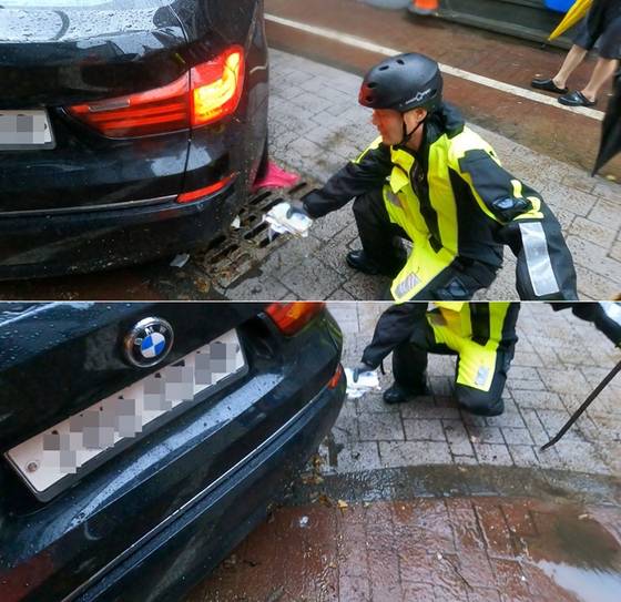 지난 17일 광주광역시 북구 중흥동 전남대 정문 도로에서 침수차량 배수작업하던 박선홍 소방위가 유실된 현금봉투를 발견한 모습. 〈사진=광주 북부소방서〉