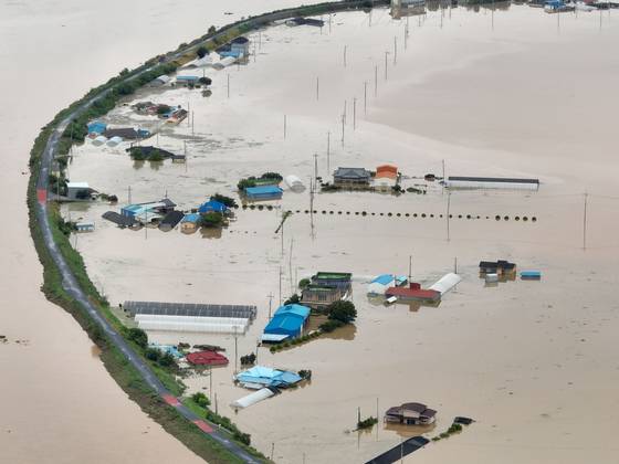 A village in Sapgyo-eup, Yesan County, South Chungcheong is submerged following heavy rainfall on July 17. [YONHAP]