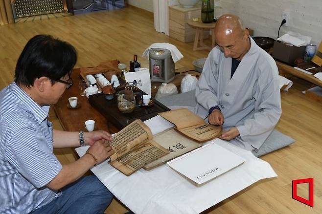 지난 18일 오후 2시경 고운사 등운 스님 차(茶)방에서 기증자 k씨와 고운사 등운 스님이 희귀 불교 전적 기증 서책을 함께 펼쳐 보이고 있다. 권병건 기자