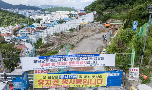 21일 부산 서구 ‘천마산 복합전망대 및 관광모노레일 조성사업’ 공사장 입구에 하청업체의 유치권 행사 현수막이 걸려 있다.    이원준 기자