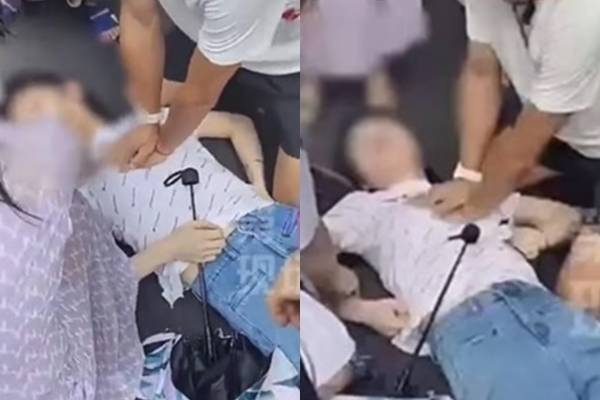 중국의 한 의과대학 교수가 길거리에서 쓰러진 여성에게 심폐소생술(CPR)을 시행하고 있다 [웨이보]