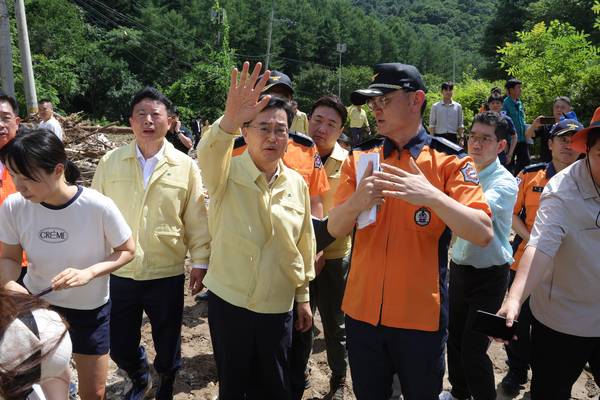 김동연 경기도지사(가운데)가 22일 오후 경기도 가평군 조종면 마일리에서 수해 현장을 살펴 보며 소방 관계자와 대화를 나누고 있다. 2025.7.22 /연합뉴스