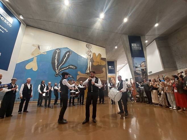 지난 12일 오후(현지시각) 파리 유네스코 본부 헤드쿼터(대강당) 홀에서 이날 프랑스 카르나크 지방 선사유적의 세계유산 등재가 확정된 것을 기념해 현지 주민들로 구성된 연주단이 자축 공연을 펼치고 있다. 연주단 뒤로 거장 파블로 피카소가 유네스코를 위해 헌정한 벽화 ‘이카루스의 몰락’(1958)이 보인다. 노형석 기자