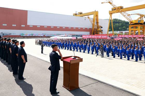 Workers, technicians and executives at Nampo Shipyard hold a rally at the shipyard on July 21, as North Korea announced plans to build a third Choe Hyon-class destroyer by Oct. 10 next year on July 22. [YONHAP]