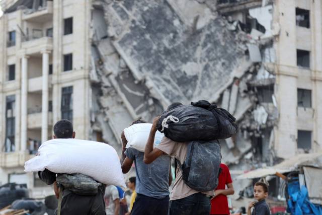 ▲22일(현지시간) 가자지구 북부 가자시티에서 팔레스타인인들이 구호 트럭이 싣고 온 구호품을 받아 나르고 있다. ⓒ로이터=연합뉴스