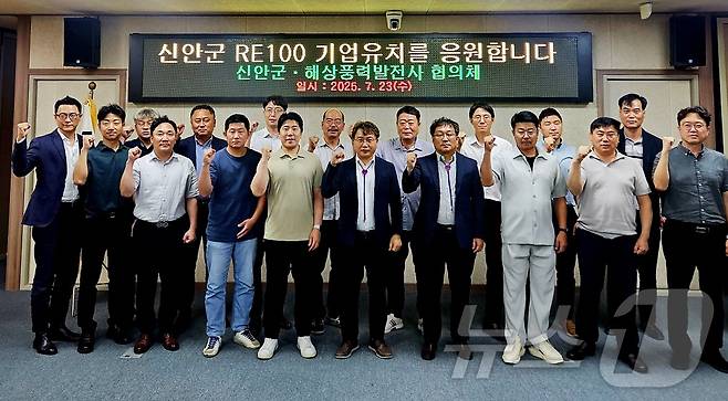 지난 23일 신안군 RE100 정책대응 간담회 참석자들이 RE100 기업유치를 응원하며 기념촬영을 하고 있다.