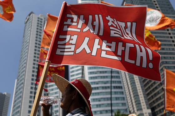 한국후계농업경영인(한농연) 경북도연맹원들이 25일 서울 용산구 삼각지역 인근에서 한-미 상호관세협상 농축산물 장벽철폐 반대 집회를 하고 있다. 뉴스1