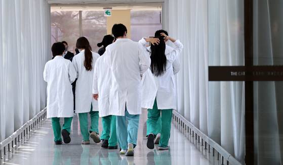 Medical professionals walk in a general hospital in downtown Seoul in March 2024. [NEWS1]
