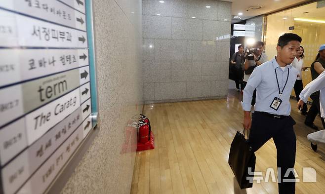 [서울=뉴시스] 조성우 기자 = 김건희 여사의 각종 의혹을 수사 중인 특별검사팀 관계자들이 25일 서울 서초구 아크로비스타 내 김 여사의 코바나컨텐츠 사무실 압수수색을 마친 뒤 철수하고 있다. 2025.07.25. xconfind@newsis.com