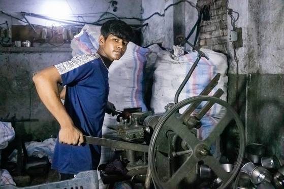 지난 8일 방글라데시 수도 다카의 한 알루미늄 공장에서 모하마드 시팟(14)이 알루미늄 그릇 연마 기계를 작동시키고 있다. 사진 유니세프