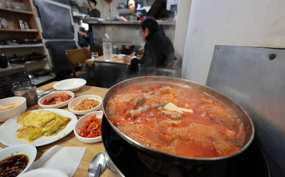 A spread for a kimchi jjigae (kimchi stew) baekban is laid out at a restaurant in Seoul on March 16. [YONHAP]