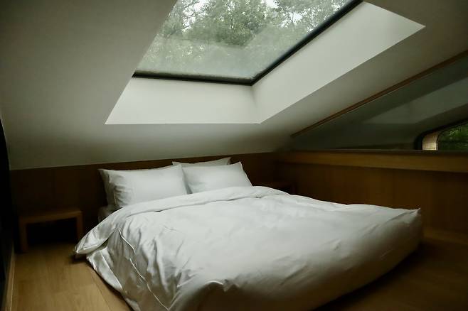A queen-sized bed in the loft inside a treehouse at wellness village Surakhyu in Nowon District in northern Seoul on June 28 [LEE SOO-JUNG]