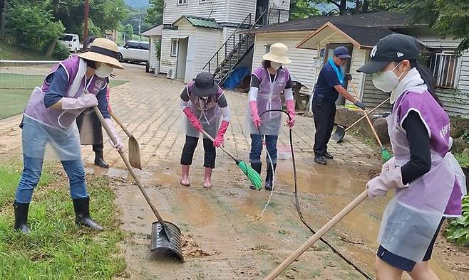 일상 회복 기원 세계평화여성연합 회원들이 25일 집중호우로 큰 피해를 입은 경기 가평군 조종면 현리에서 복구 활동을 하고 있다.