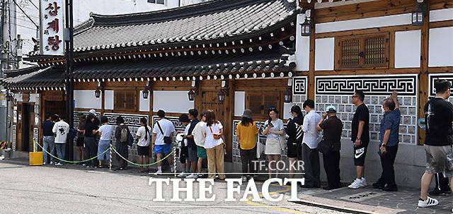 절기 상 더위가 가장 심하다는 삼복 중 두 번째에 해당하는 중복인 30일 전국 대부분 지역에서 폭염특보와 열대야가 지속되고 있다. 사진은 중복을 맞아 서울 종로구의 한 삼계탕집 앞에 줄을 서고 있는 시민들 모습. /임영무 기자