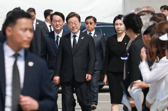 이재명 대통령과 김혜경 여사가 지난달 6일 서울 동작구 국립서울현충원에서 열린 70회 현충일 추념식에 입장하고 있다. 권혁기 의전비서관 내정자(왼쪽), 박관천 대통령경호처 차장 내정자(대통령 오른쪽 뒤)가 이 대통령 부부를 수행하고 있다. 연합뉴스