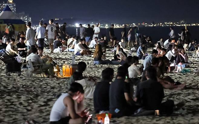 지난 27일 자정 무렵 강원 강릉시 경포해수욕장 백사장이 피서 절정기를 맞아 열대야에 지친 피서객들이 몰려 북적이고 있다. 연합뉴스