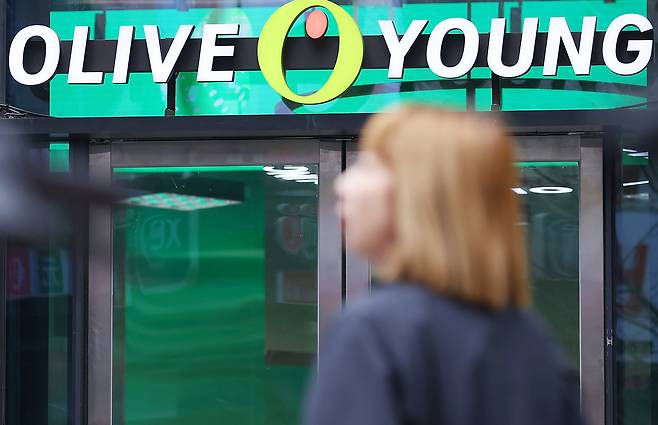 A pedestrian walks by a Olive Young branch in Seoul on March 12. [YONHAP]