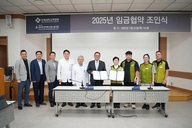 지난 7월 31일 부산백병원 강당에서 가진 ‘2025년 임금협약 조인식’에 참석한 백중앙의료원 노사 관계자들이 기념촬영을 하고 있다. 인제대학교 백병원 제공