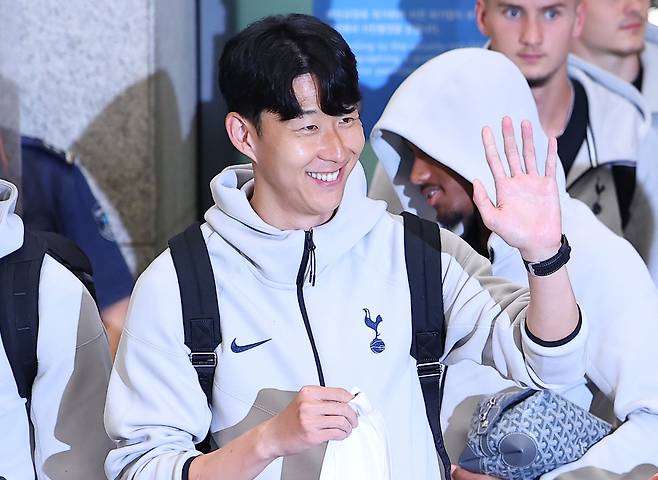 손흥민이 지난 1일 인천국제공항 제1터미널을 통해 입국하며 팬들에게 손을 흔들고 있다.  [연합]