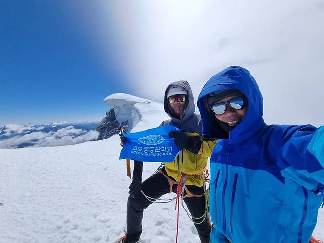 문성욱(오른쪽)·우석주 산악인이 알프스 6대 북벽 중 하나로 꼽히는 ‘프랑스 그랑드조라스’ 정상에서 사진 촬영을 하고 있다. <코오롱인더스트리>