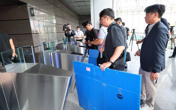 경기남부경찰청과 고용노동부 관계자들이 경기도 광명시 포스코이앤씨 고속도로 건설공사 현장의 미얀마인 근로자 감전 사고와 관련해 12일 포스코이앤씨 인천 본사(인천 연수구) 압수수색을 위해 사옥으로 들어가고 있다.   지난 4일 경기도 광명시 광명~서울고속도로 연장공사 현장에서 미얀마 국적의 30대 남성 근로자가 지하 물웅덩이에 설치된 양수기 펌프를 점검하다 감전으로 추정되는 사고를 당해 현재까지 의식을 되찾지 못하고 있다. 연합뉴스