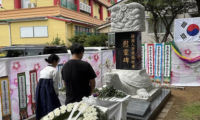 지난 8일 나가사키 한국인 원폭 희생자 위령비 앞에서 열린 위령제에서 참석자들이 헌화한 뒤 묵념하고 있다.